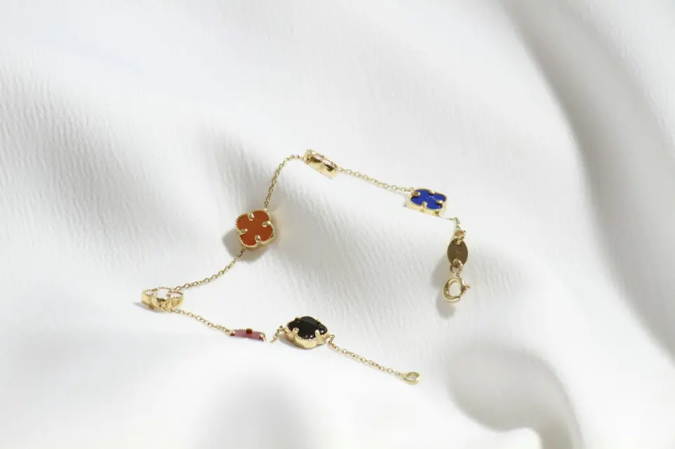 a close up of a bracelet on a white cloth